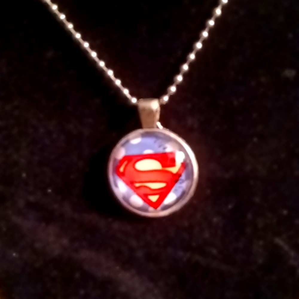 Superman round glass pendant with chain.